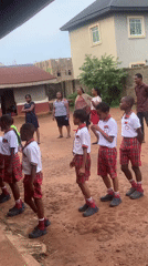 Schoolboys in uniforms walk outdoors in Ukwu-Abwa, Nigeria