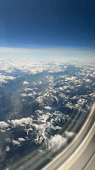 Traveler documents flight arrival in Zurich with mountain views