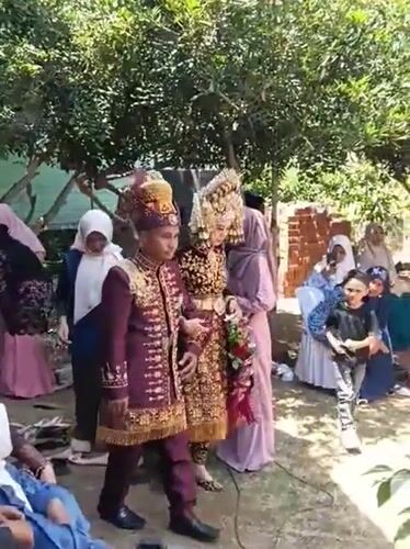Traditional wedding ceremony on patterned red carpet in Indonesia