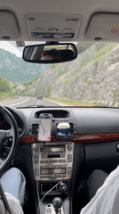 Driver travels Montenegro highway with navigation and coffee