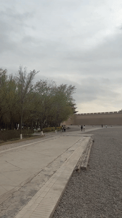 Tourists explore historic Jiayuguan Fortress under overcast skies