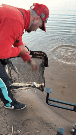 Fisherman weighs and releases catch at Chaykovsky lake