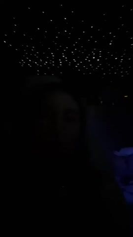 A dark video shows a person's face illuminated by what appears to be a starry ceiling. The person's eyes are visible, and they are looking towards the camera. The rest of the person's body and the surrounding environment are obscured by darkness. The starry ceiling is lit with small, white lights that resemble stars. There is a hint of blue light in the background, which might be from an ambient light source. The video is brief, lasting only a few seconds, and the audio consists of a few words spoken in Romanian.