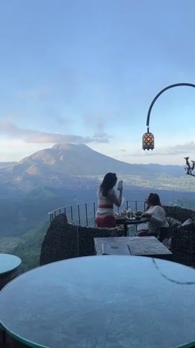 Women dine with mountain views at Kintamani restaurant terrace