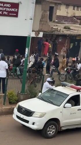 Official-looking pickup parked outside Bukuru microfinance bank