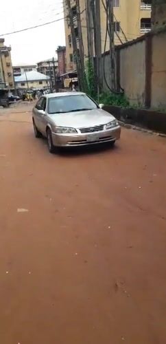 Morning street life documented on dirt roads in Onitsha