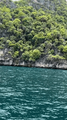 Boat passenger films tropical island off Haad Yao Thailand
