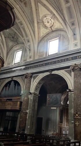Visitor documents ornate Milan church interior including bone ossuary