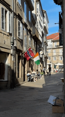 Sun-lit cobblestone street in Santiago de Compostela's old quarter