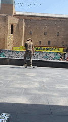 Skateboarder performs ledge trick in Barcelona public square