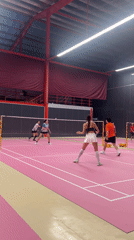 Badminton doubles match played on pink indoor court in Ko Samui