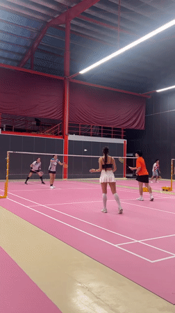 Badminton doubles match played on pink indoor court in Ko Samui