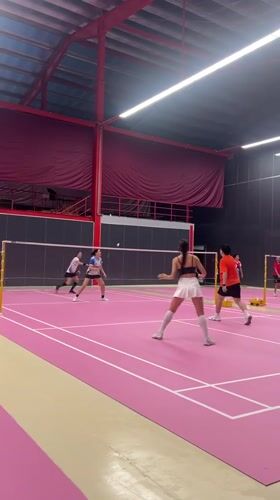 Badminton doubles match played on pink indoor court in Ko Samui