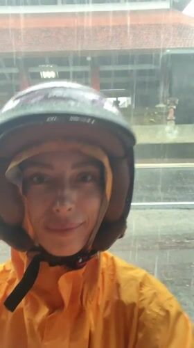 Woman takes rainy day selfie in Abiansemal, Indonesia