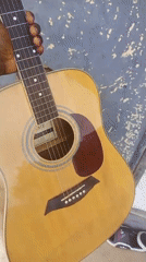 Acoustic guitar with capo, up close in Serti