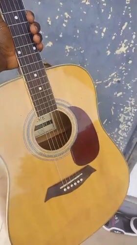 Acoustic guitar with capo, up close in Serti