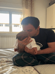 Father tenderly holds newborn baby in Aprilia, Italy