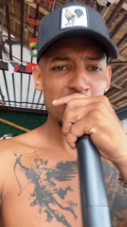 Tattooed man performs at Playa del Carmen bar