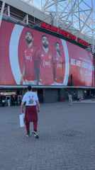 Man in maroon and white walks from Old Trafford