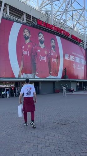 Man in maroon and white walks from Old Trafford