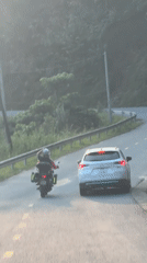 Motorcyclist travels mountain road in Tân Quang Commune, Vietnam