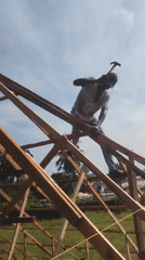 Construction worker on roof frame in Agbarha Otor, Nigeria
