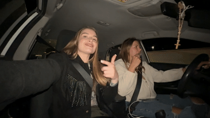 Young women take nighttime car selfies in Montenegro