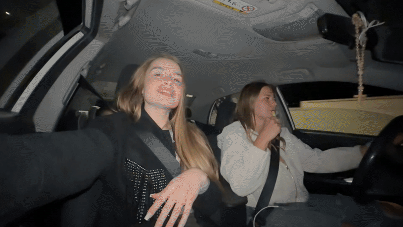 Young women take nighttime car selfies in Montenegro