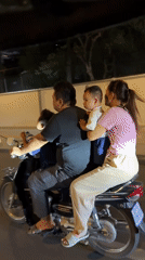 Three-up motorcycle ride through Phnom Penh at night