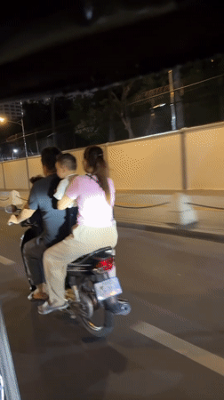 Three-up motorcycle ride through Phnom Penh at night