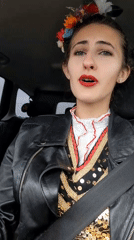 Woman sings in traditional Bulgarian dress while driving in Sofia