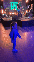 Band night out, kid in tow, dancing by the stage