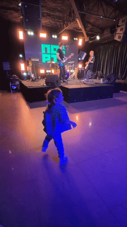 Band night out, kid in tow, dancing by the stage