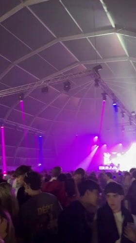 Crowded tent venue event in Sanxenxo under professional lighting
