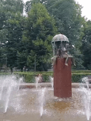 Tallinn street scene: park fountain and city tram