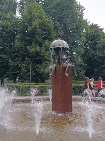 Tallinn street scene: park fountain and city tram