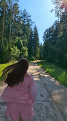 Woman photographed on forest road near Chaykovsky, Russia