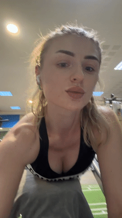 Woman documents gym workout session with mirror selfies