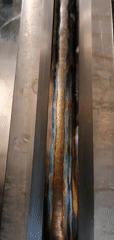 Industrial welding workspace documented with colorful personal decorations
