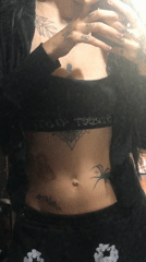 Tattooed person uses phone in bed in Buenos Aires