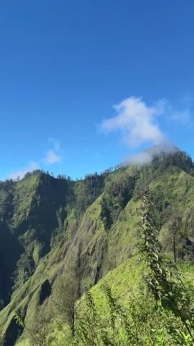 Hikers navigate steep trails amid Kintamani's lush mountain landscapes