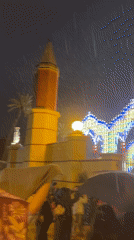 Heavy rain falls on illuminated arches in Jerez, Spain