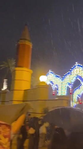 Heavy rain falls on illuminated arches in Jerez, Spain