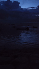 Evening waterfront activities documented in Denpasar harbor area