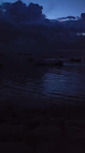 Evening waterfront activities documented in Denpasar harbor area