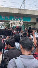 Young men hold rally near monument in Dhaka