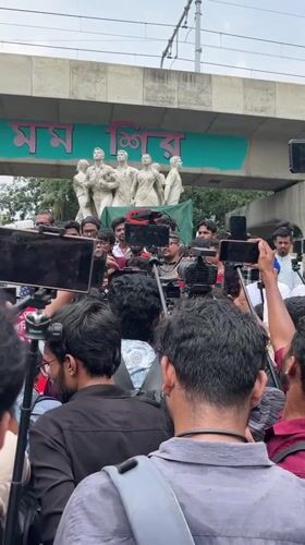 Young men hold rally near monument in Dhaka