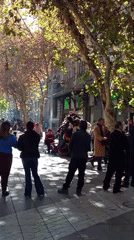 Street gathering with colorful items observed in Santiago