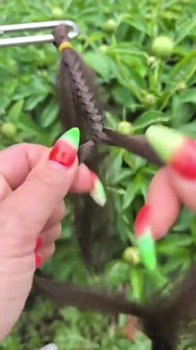 Person with watermelon nail art braids hair in Russia