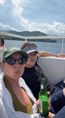 Tourists enjoy sunny boat trip near Indonesian island